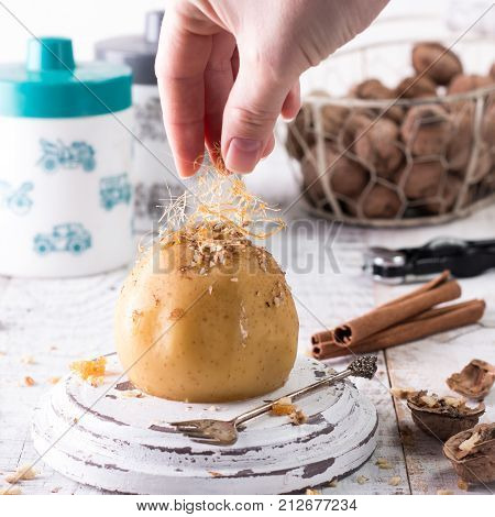 Baked Apples Stuffed With Raisins, Walnuts And Honey On A Plate