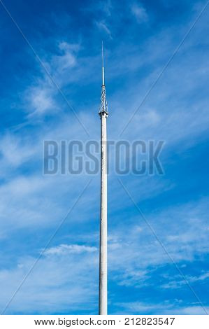 Lightning rod on the concrete pillar on blue sky background