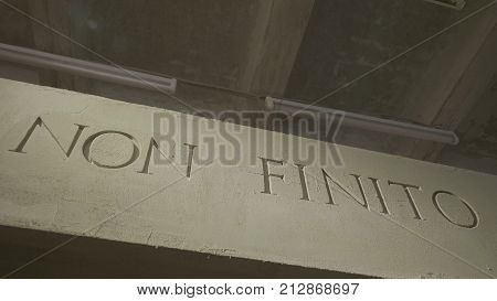 The Inscription That Means It Is Not The End On The Grey Wall. Isolated Non Finito Text, Acronym Of 