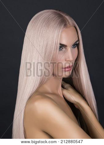 Doll looking model. Long cold pink smoothy hair. Posing in studio nacked.