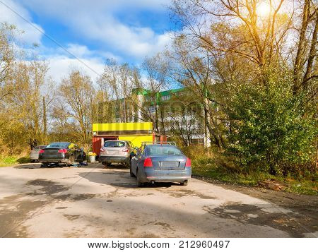 Modern cars are queuing on the tire service. Seasonal tyre replacement. Autumn in Krasnoe Selo. Saint-Petersburg Russia