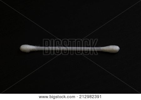 Single qtip on a black background close up macro shot