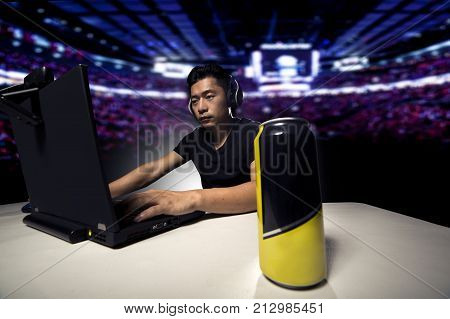 Competitive eSport video game player drinking a canned energy drink as a stimulant. These beverage often contain caffeine and guarana.