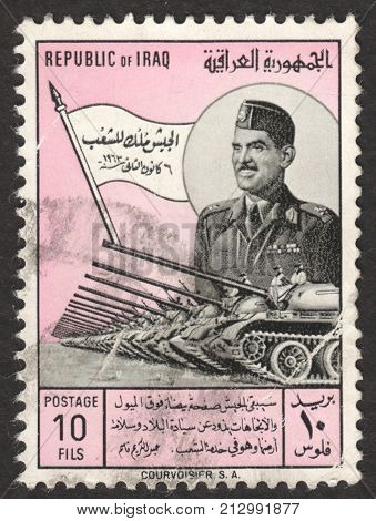 MOSCOW RUSSIA - CIRCA OCTOBER 2017: a post stamp printed in IRAQ shows General Kassem and tank parade the series " The Army Day" circa 1963