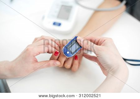 The Doctor Puts On The Sensor Measuring The Pulse And Oxygen In The Blood On The Patients Finger