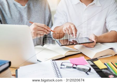 High School Or College Students Studying And Reading Together In Library