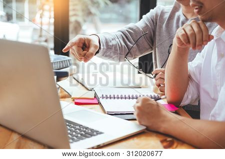 High School Or College Students Studying And Reading Together In Library