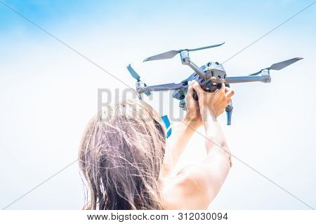 A Woman Launches A Drone For Flight, With Which You Can Take Photos And Video Filming