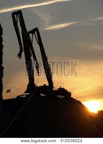 Excavation Work. Excavator At Construction Site With Sunset