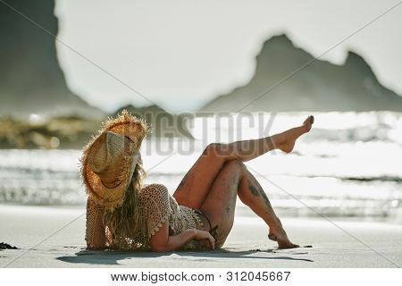 young woman relaxing on the beach in summer day