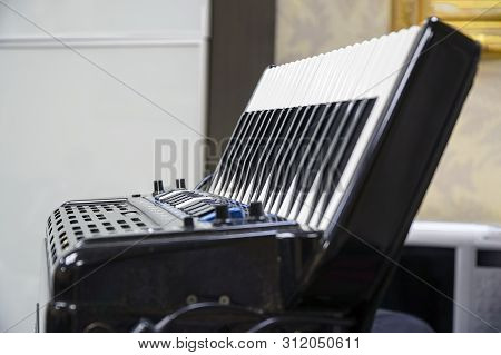 Keyboard Accordion Standing On The Table. Selective Focus