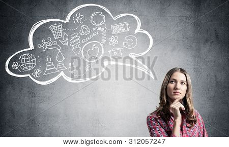 Serious Woman Looks Pensive Upwards And Thinking Something. Speech Bubble With Ecology And Environme