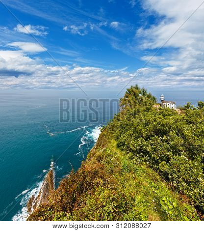 Getaria Lighthouse Is Located At The End Getaria Mouse (symbol Of Town), On Mount San Anton. Spain, 
