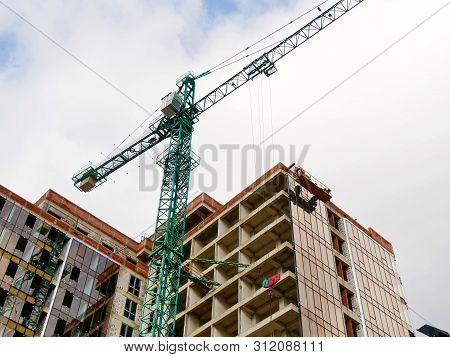 Construction Site Background. Hoisting Cranes And New Multi-storey Buildings. I.ndustrial Background