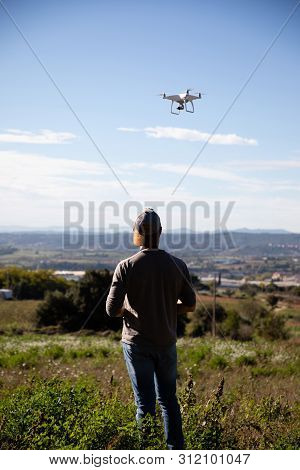 Man Playing With Drone On The Open Field
