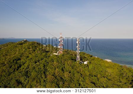 Telecommunication Tower, Communication Antenna. Repeaters On A Metal Tower. Landscape With Hills And