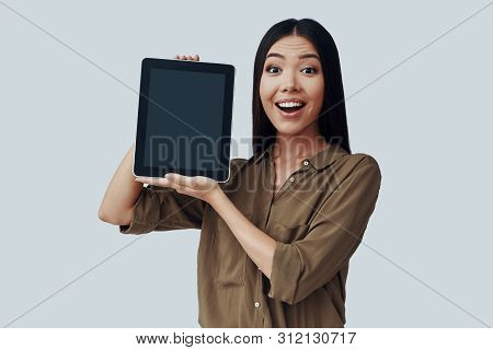 Look Over Here! Beautiful Young Asian Woman Looking At Camera And Making A Face While Standing Again