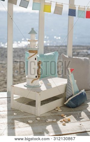 Omposition With Beach Decoration Shells, Boat And Lighthouse, With Pillowson Wave Ocean Background, 