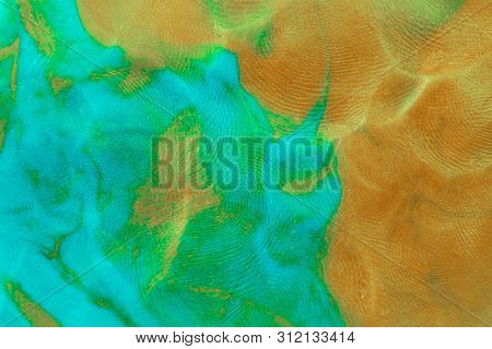 Mixed Brown-green Flat Plasticine Texture With Distinct Fingerprints. Small Dust Particles On Surfac