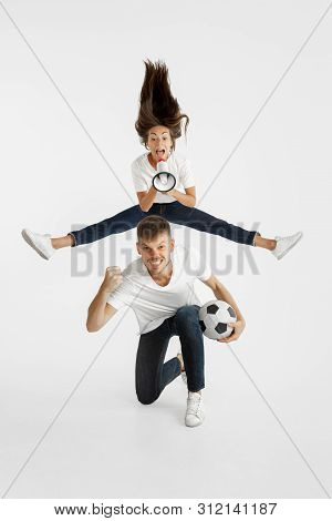 Portrait Of Beautiful Young Couple Football Or Soccer Fans On White Studio Background. Facial Expres