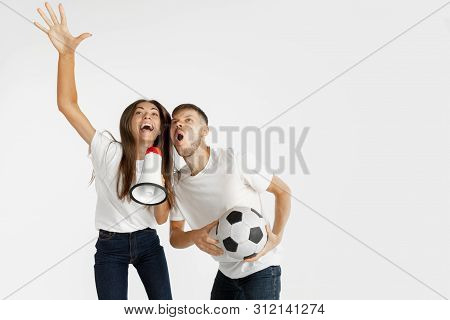 Portrait Of Beautiful Young Couple Football Or Soccer Fans On White Studio Background. Facial Expres
