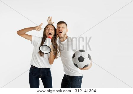Portrait Of Beautiful Young Couple Football Or Soccer Fans On White Studio Background. Facial Expres