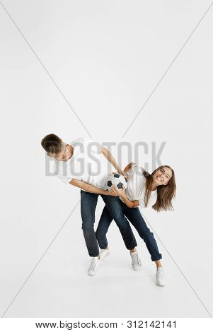 Portrait Of Beautiful Young Couple Football Or Soccer Fans On White Studio Background. Facial Expres