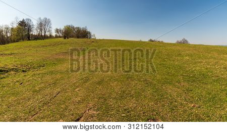 Springtime Meadow With Few Trees And Clear Sky In Javorniky Mountains Above Cadca City In Slovakia