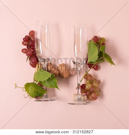 Alphabet. Letter H Made Of Wineglasses With Rose And White Wine, Grapes, Leaves And Corks Lying On P