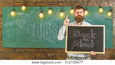 Back To School Concept. Teacher In Eyeglasses Holds Blackboard With Inscription Back To School. Man 
