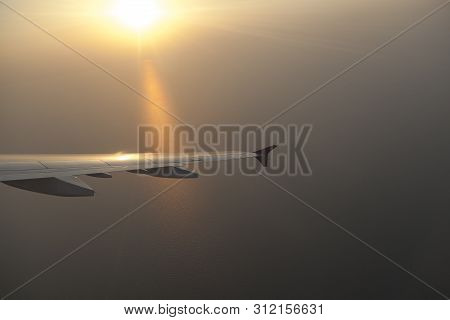 Wing Of The Plane At Landing, Beautiful Sunset, View From The Plane's Window, At The Bottom Of The S