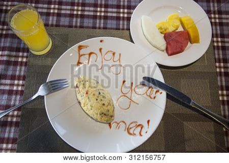 Breakfast With Scrambled Eggs, With Fruit And Juice, The Inscription On The Plate 
