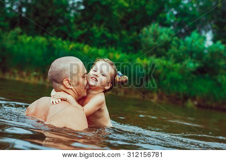 Happy Family Father And Son. Dad Teaches His Son To Swim