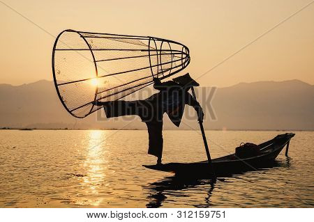 Man Catching Fish On Inle Lake (shan State)
