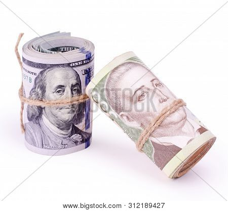 Tubes Of United States Dollars And Ukrainian Hryvnia Uah Banknotes Isolated On A White. Financial Bu