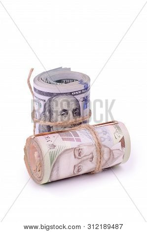 Tubes Of United States Dollars And Ukrainian Hryvnia Uah Banknotes Isolated On A White. Financial Bu