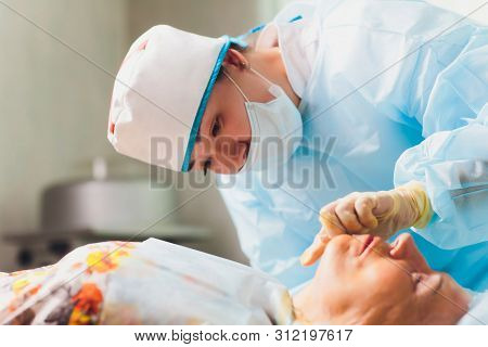 Aged Woman Doing Mesothreads And Thread Lifting, Cosmetology. Cosmetic Procedure To Eliminate Signs 