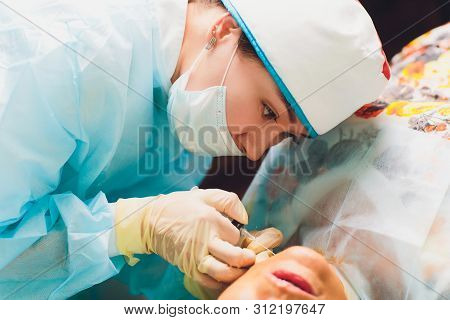 Aged Woman Doing Mesothreads And Thread Lifting, Cosmetology. Cosmetic Procedure To Eliminate Signs 