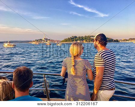 Rovinj, Croatia - July 4th, 2019: A Young Couple Look For Dolphins During An Evening Dolphin Watchin