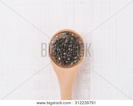 Wet Chia Seeds Or Chia-egg In Wooden Spoon On White Wooden Background. Egg Replacers, Plant Based Eg
