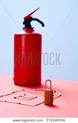 Fire Safety, Or Security And Protection Concept. A Fire Extinguisher, The Figure Of The House And Lo