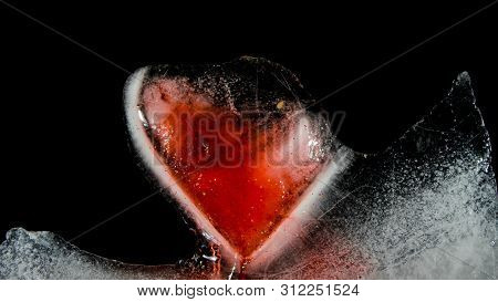 Red Heart In Ice Melting, Looks Like It Is Bleeding. Love - Leaving.