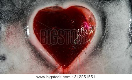Red Heart In Ice Melting, Looks Like It Is Bleeding. Love - Leaving.