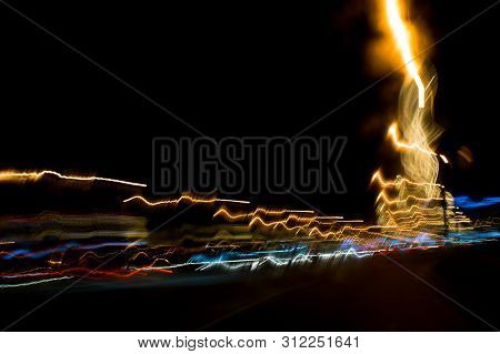 A View Through The Windshield While Driving At Night. Long Exposure. Artistic, Abstract.