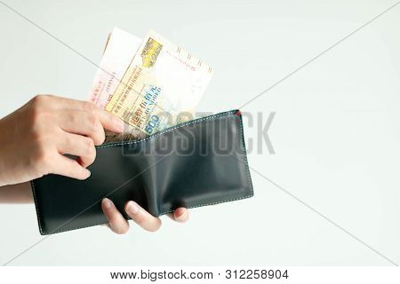 White Background Photo Of Hands Holding A Short Wallet And Another Hand Bring Hong Kong Money (curre