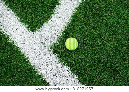 On The Field With Markings And Artificial Turf Is A Ball For Tennis.