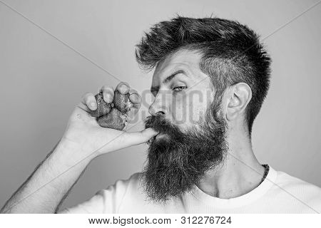 Hipster Bearded Holds Strawberries Fist As Juice Bottle. Man Strict Face Enjoy Fresh Drink Strawberr