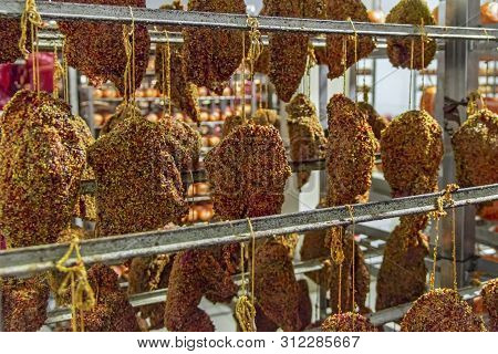 Smoked Meat Hams With Spices And Herbs Hanging On The Counter. Traditional Smoked Meats: Ham,gammon,