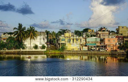 Mahebourg, Mauritius - Jan 5, 2017. River Scene With A Small Village At Sunset In Mahebourg, Mauriti
