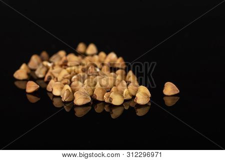 Lot Of Whole Raw Brown Buckwheat Grain Heap Isolated On Black Glass